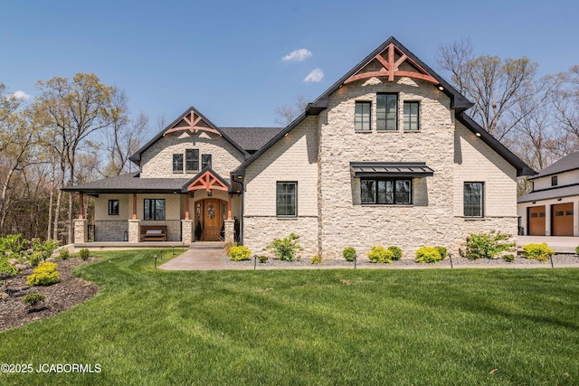 victorian-style house featuring a porch, stone siding, and a front yard