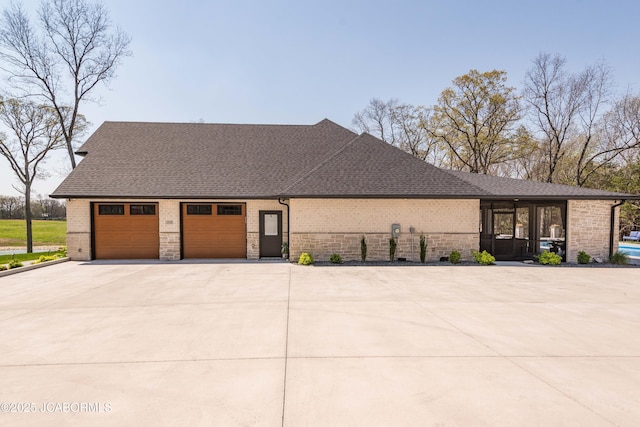 view of property exterior featuring brick siding, an attached garage, a shingled roof, and concrete driveway