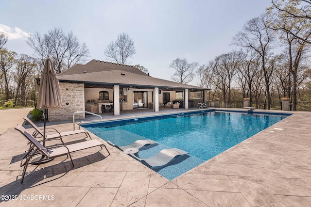 view of pool with a ceiling fan, outdoor dry bar, fence, a patio, and a fenced in pool