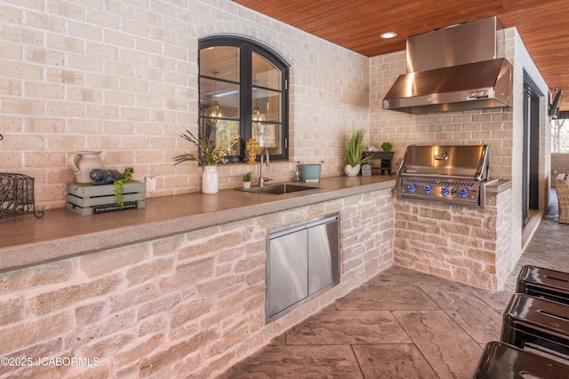 view of patio with exterior kitchen, a sink, and area for grilling