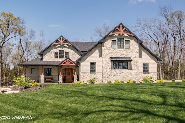 view of front facade featuring stone siding, covered porch, and a front yard