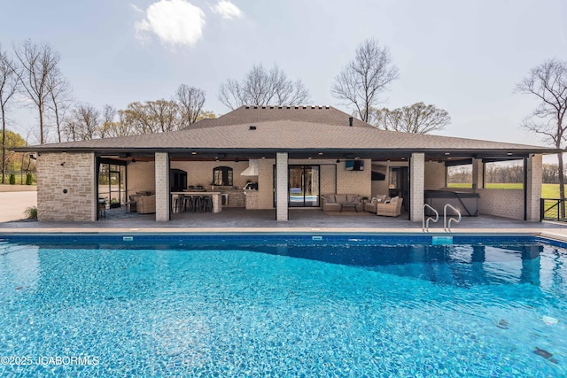 outdoor pool with ceiling fan, an outdoor hangout area, outdoor dry bar, and a patio