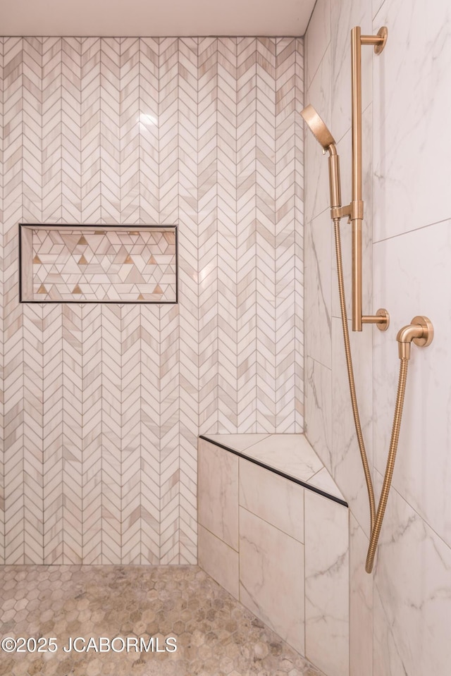 full bathroom with tiled shower