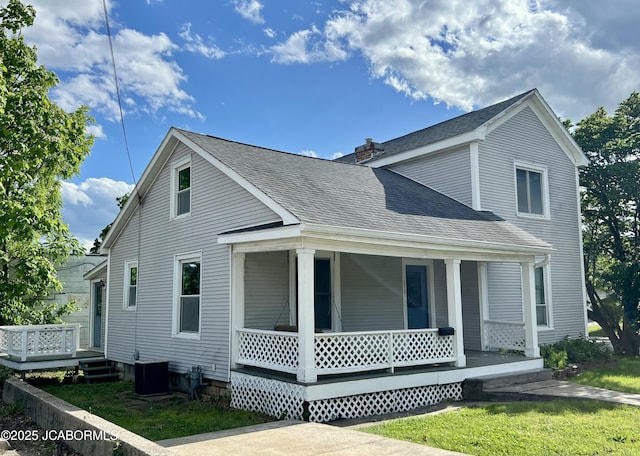 112 W 6th St, Fulton, MO 65251 - view of front of house featuring a porch, a shingled roof, central AC unit, a chimney, and a front lawn