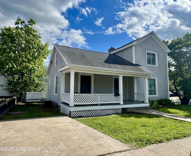 112 W 6th St, Fulton, MO 65251 - view of front of property with a porch, a front lawn, roof with shingles, central air condition unit, and a chimney