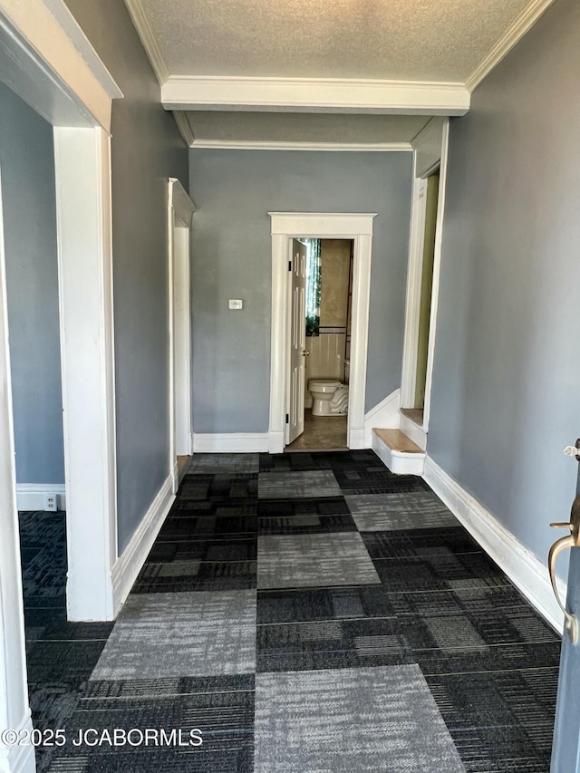112 W 6th St, Fulton, MO 65251 - hall featuring dark colored carpet, a textured ceiling, crown molding, and baseboards