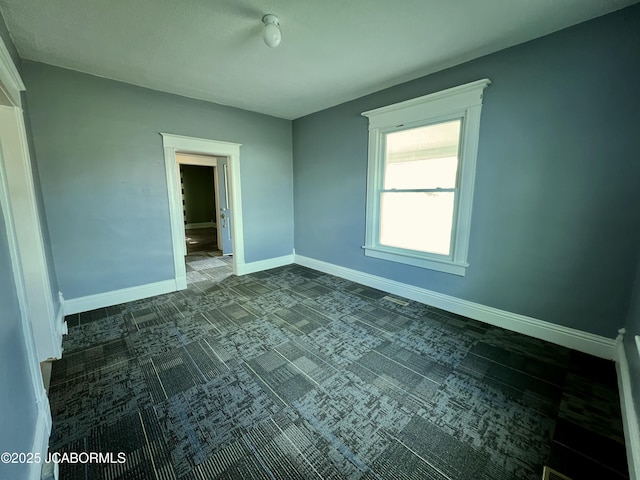 112 W 6th St, Fulton, MO 65251 - empty room featuring baseboards and dark carpet