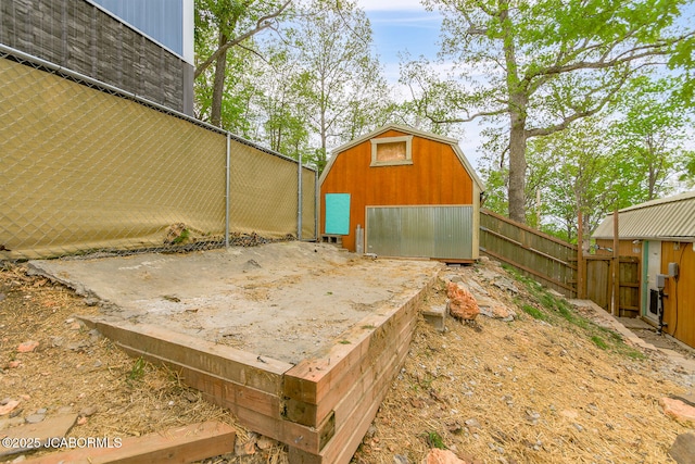 view of yard with an outbuilding, a storage unit, and fence