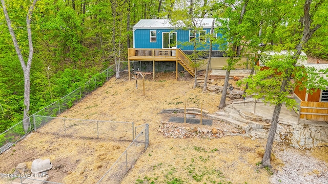 exterior space featuring a wooden deck, stairway, and fence