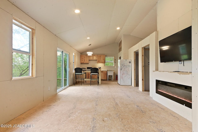 unfurnished living room featuring recessed lighting and lofted ceiling