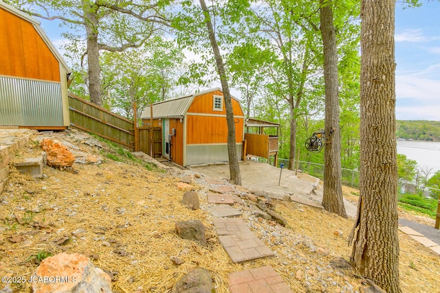 view of yard featuring an outbuilding and fence