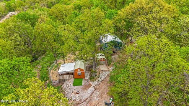 birds eye view of property with a forest view