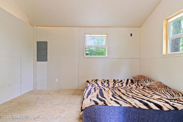bedroom featuring electric panel and lofted ceiling