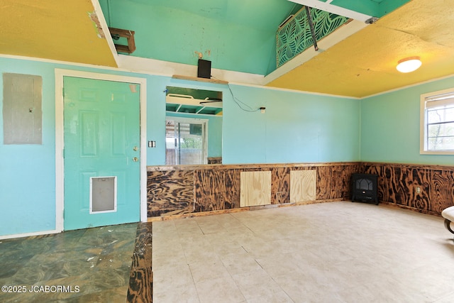 spare room featuring a wainscoted wall and electric panel