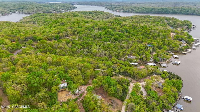 aerial view with a water view and a forest view