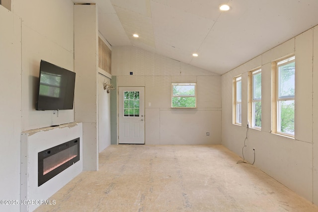 unfurnished living room featuring recessed lighting and vaulted ceiling