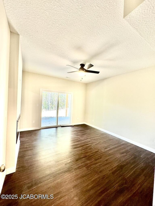 1680 W Fenton Rd, Columbia, MO 65202 - empty room featuring dark wood finished floors, baseboards, ceiling fan, and a textured ceiling