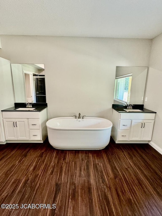 1680 W Fenton Rd, Columbia, MO 65202 - full bath featuring a freestanding tub, wood finished floors, and two vanities