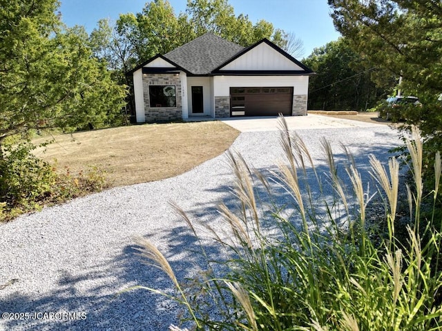 1680 W Fenton Rd, Columbia, MO 65202 - view of front of house featuring a garage, roof with shingles, concrete driveway, and stone siding