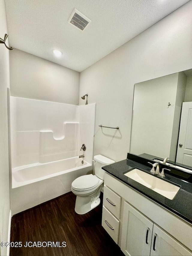 1680 W Fenton Rd, Columbia, MO 65202 - full bathroom featuring visible vents, toilet, shower / bath combination, wood finished floors, and vanity
