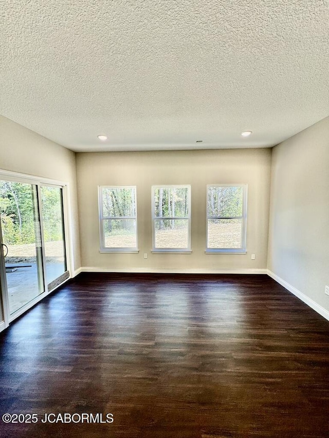 1680 W Fenton Rd, Columbia, MO 65202 - spare room featuring a textured ceiling, wood finished floors, recessed lighting, and baseboards