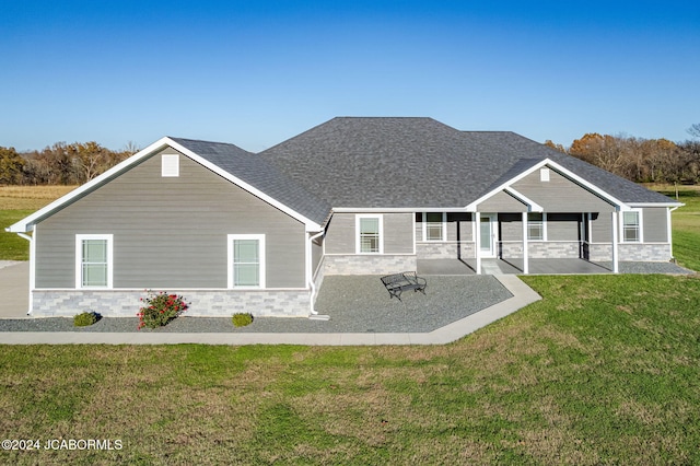 view of front of house featuring a patio area and a front lawn