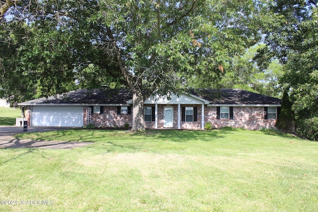 ranch-style home with a garage and a front yard