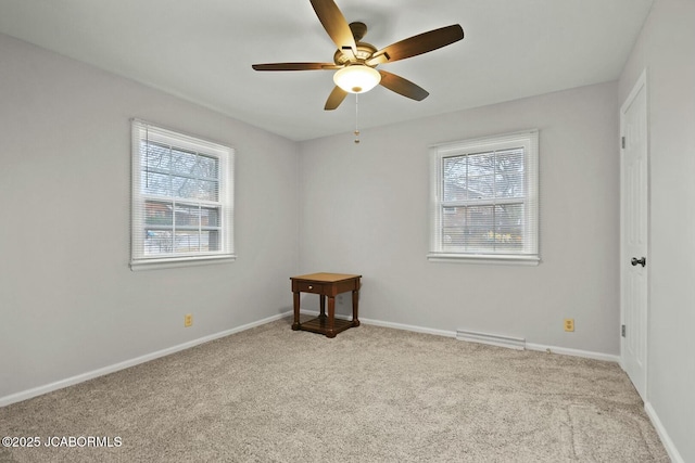 unfurnished room with carpet flooring, visible vents, baseboards, and a ceiling fan