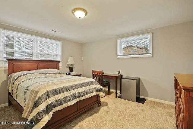 carpeted bedroom with visible vents and baseboards