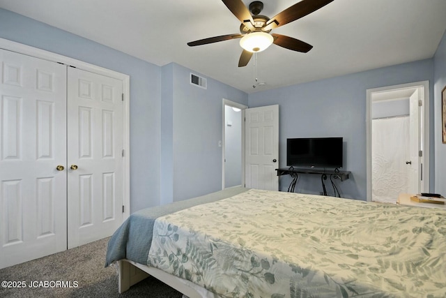 bedroom featuring carpet, visible vents, ensuite bath, ceiling fan, and a closet