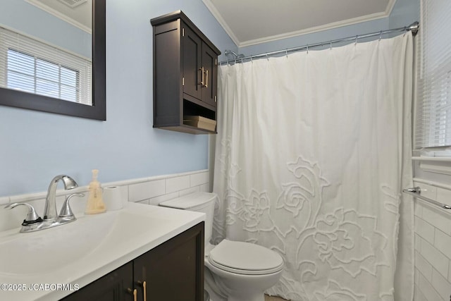 full bathroom featuring vanity, crown molding, toilet, and tile walls