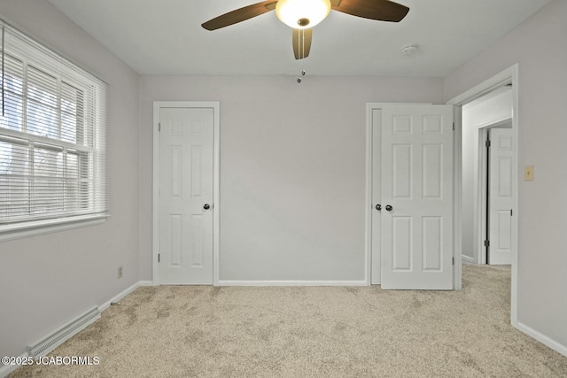 unfurnished bedroom featuring a ceiling fan, baseboards, and carpet floors