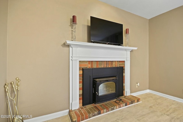 details with a brick fireplace and baseboards