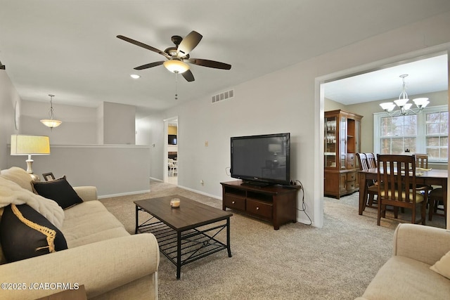 carpeted living area with recessed lighting, visible vents, baseboards, and ceiling fan with notable chandelier