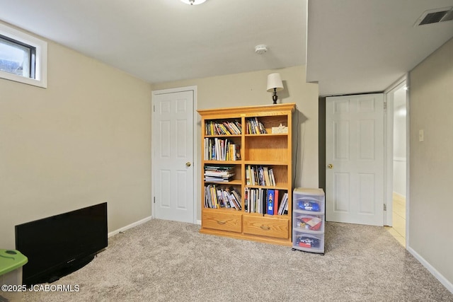 interior space featuring visible vents, baseboards, and carpet