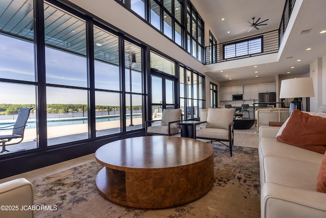 100 Blue Heron Hill Ln Unit 103, Lake Ozark, MO 65049 - living area featuring a towering ceiling, recessed lighting, and a ceiling fan
