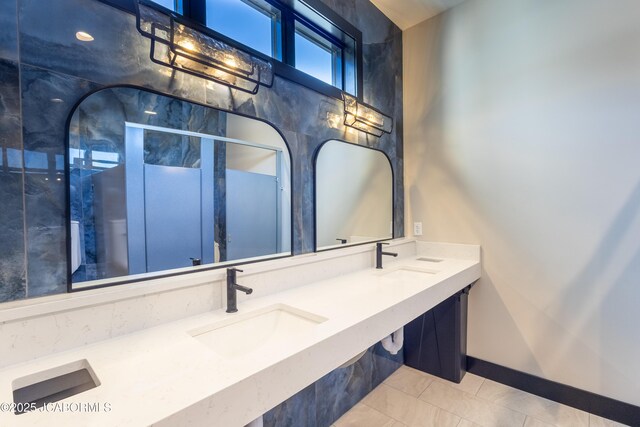 100 Blue Heron Hill Ln Unit 103, Lake Ozark, MO 65049 - bathroom featuring double vanity and baseboards
