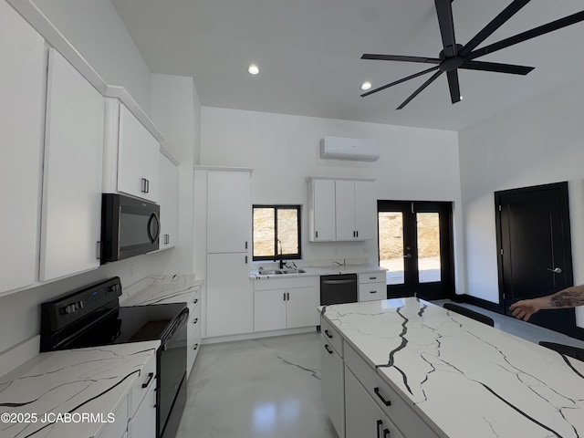 100 Blue Heron Hill Ln Unit 103, Lake Ozark, MO 65049 - kitchen featuring black appliances, a wall mounted air conditioner, french doors, light stone countertops, and recessed lighting