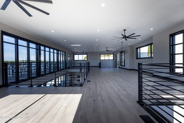 100 Blue Heron Hill Ln Unit 103, Lake Ozark, MO 65049 - unfurnished living room featuring a ceiling fan, recessed lighting, and wood finished floors