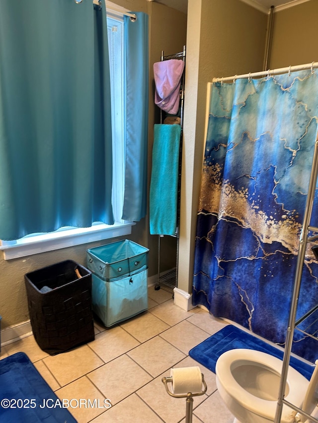 bathroom featuring tile patterned flooring and toilet