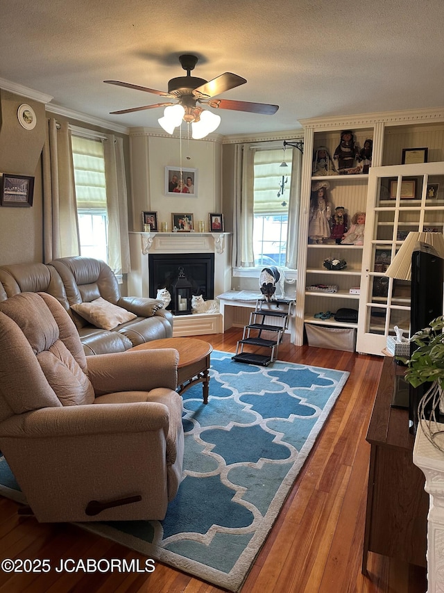 living room featuring a wealth of natural light, crown molding, hardwood / wood-style floors, and a textured ceiling