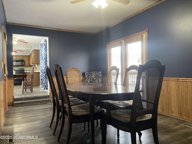 dining room with ornamental molding, dark hardwood / wood-style flooring, a textured ceiling, and ceiling fan