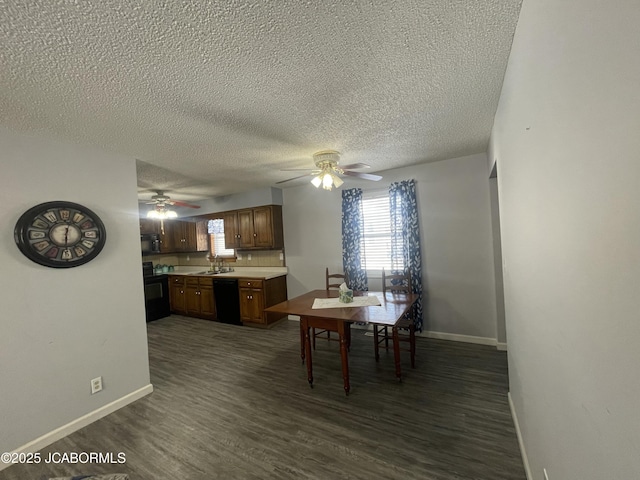 dining space with a textured ceiling, dark wood-style flooring, a ceiling fan, and baseboards