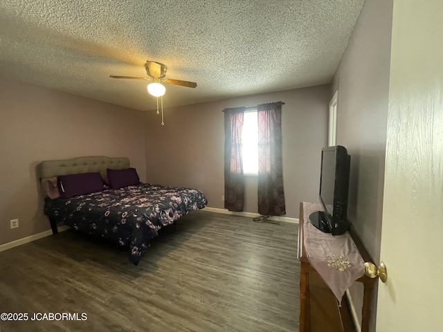 bedroom with a ceiling fan, a textured ceiling, baseboards, and wood finished floors