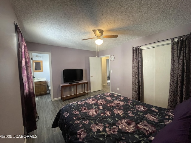 bedroom with ensuite bathroom, a textured ceiling, ceiling fan, and light hardwood / wood-style floors