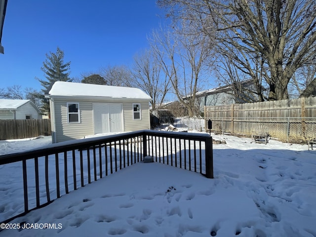 snow covered deck featuring an outdoor structure