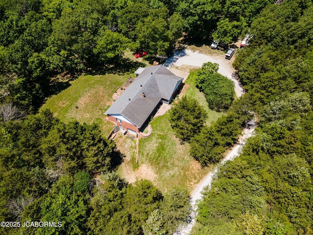 drone / aerial view featuring a wooded view