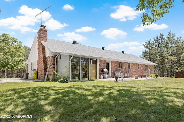 back of property featuring brick siding and a lawn