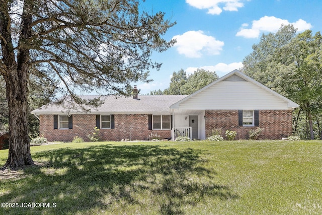 single story home featuring a front lawn, brick siding, and a shingled roof