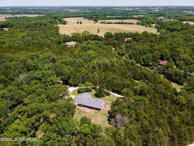 bird's eye view featuring a wooded view